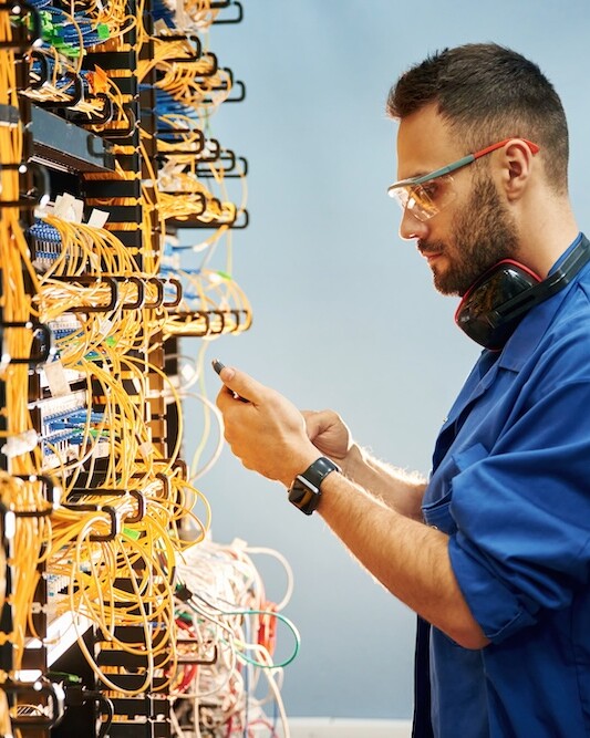 WhatzIndustry - side view young man is working with internet equi 2025 03 18 20 35 32 utc uai